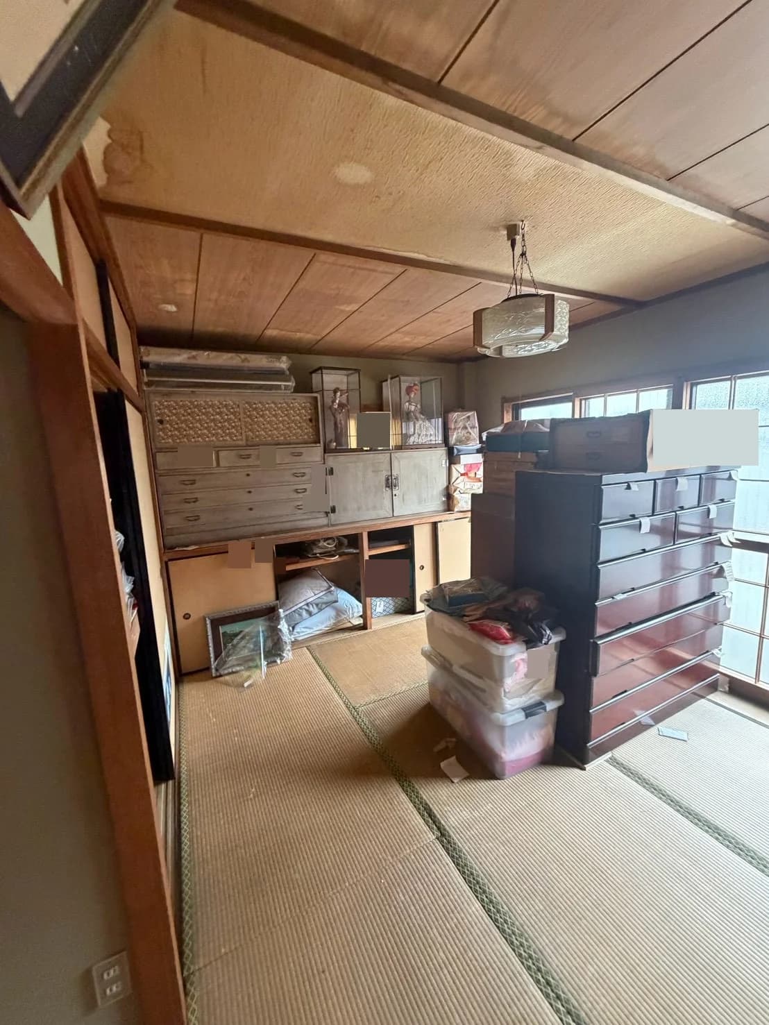 和室に置かれた複数のたんす、収納ケース、飾り物
